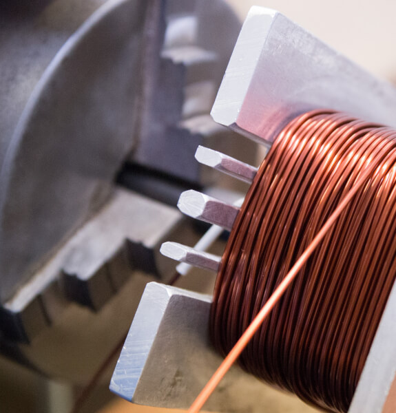 Copper coil being wound for custom torodial transformers